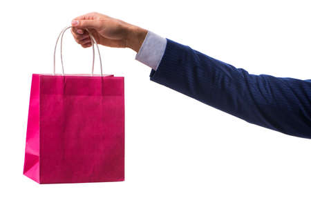 Hand holding shopping bags with christmas shopping on white backgroundの写真素材