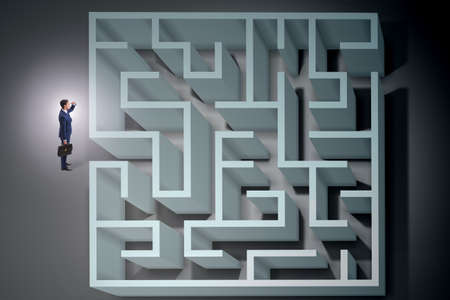 Businessman is trying to escape from maze labyrinthの写真素材