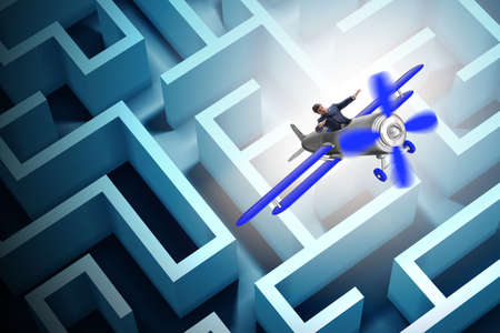 Businessman escaping from maze on airplaneの写真素材