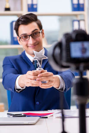 Businessman recording a video for vlogの写真素材