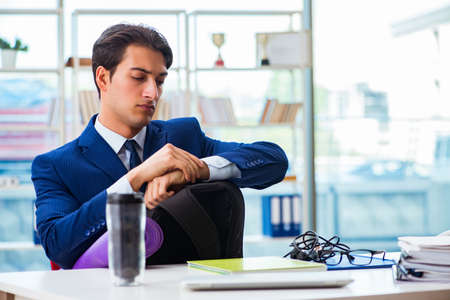 Man getting ready for sports break in the officeの写真素材