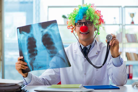 Pediatrician with x-ray image sitting in the officeの写真素材