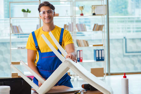 Furniture repairman working on repairing the chairの写真素材