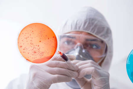 Chemist working in the laboratory with hazardous chemicals