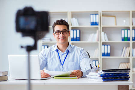 Business blogger doing webcast for his subscribersの写真素材