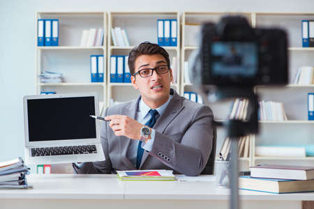 Business blogger doing webcast for his subscribersの写真素材