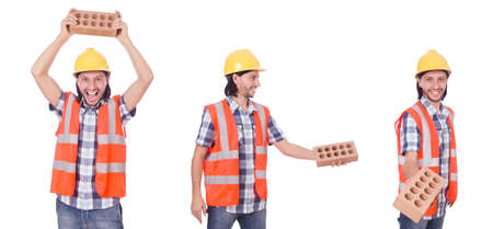 Young bricklayer with brick isolated on white backgroundの写真素材