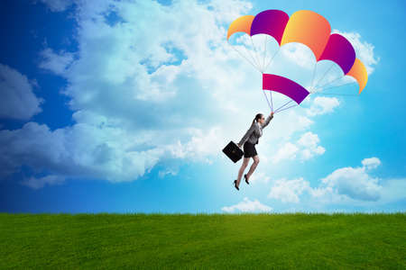 Businesswoman flying on parachute in business concept