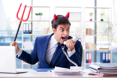 Devil angry businessman in the officeの写真素材