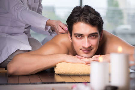 Young handsome man during spa procedureの写真素材