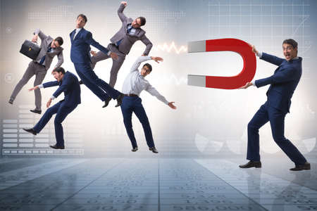 Businessman in recruitment concept with horseshoe magnet