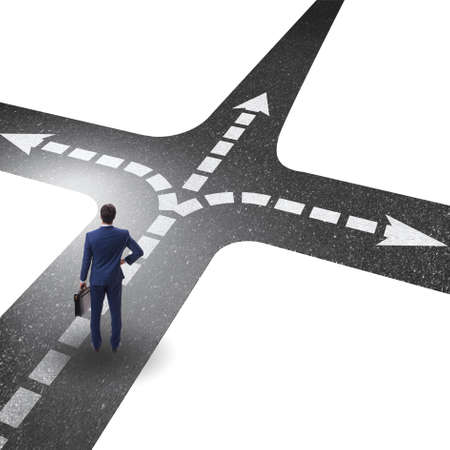 Young businessman at crossroads in uncertainty concept
