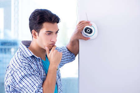 Man installing surveillance CCTV cameras at home