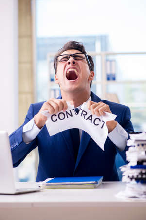 Businessman with message in the office at deskの写真素材