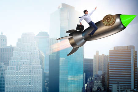 Businessman flying on rocket in bitcoin price rising conceptの写真素材