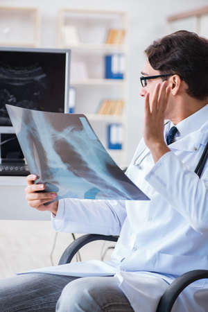 Doctor radiologist looking at x-ray imagesの写真素材