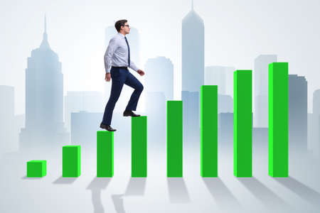 Businessman going up the bar chart in growth conceptの写真素材