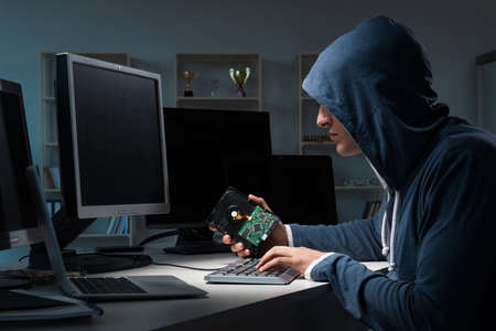 Hacker hacking computer at night