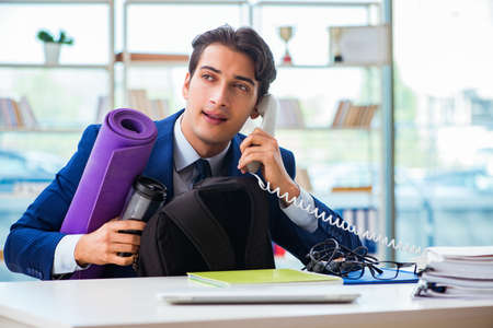 Man getting ready for sports break in the officeの写真素材