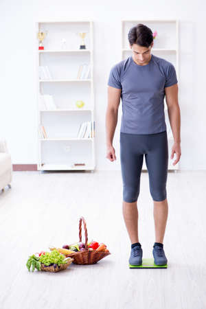 Man promoting the benefits of healthy eating and doing sportsの写真素材