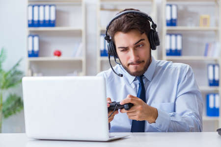 Businessman gamer in office playing games