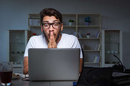 Young man staying late in office to do overtime work