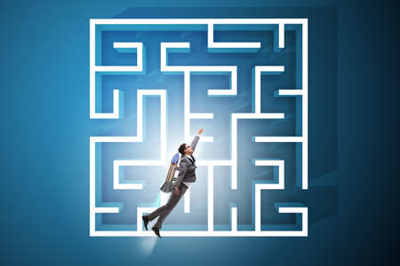 Uncertainty concept with businessman lost in maze labyrinthの写真素材