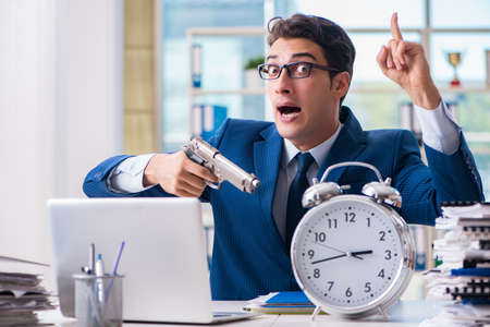 Stressed businessman thinking of suicide due to excessive workloadの写真素材