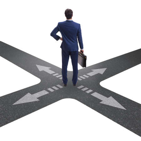 Young businessman at crossroads in uncertainty conceptの写真素材