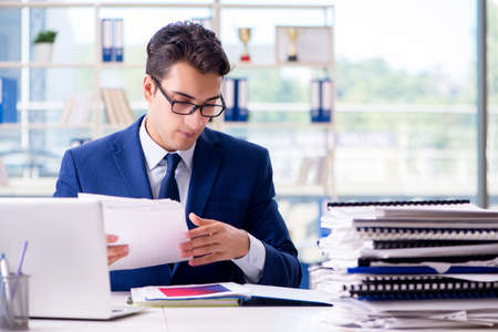 Businessman working with paperwork in the officeの写真素材