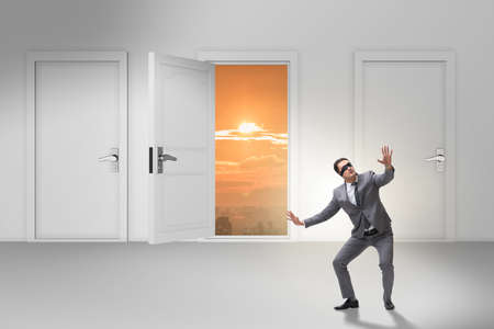Confused businessman in front of doorsの写真素材