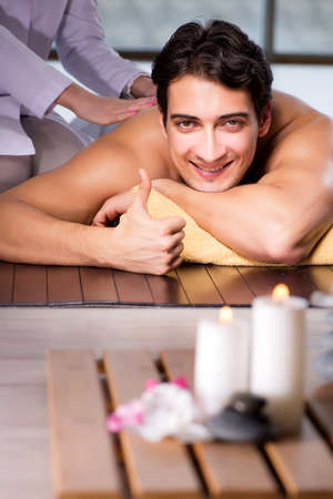 Young handsome man during spa procedureの写真素材