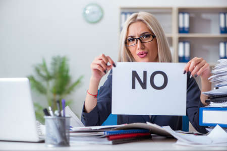 Businesswoman with message in office at deskの写真素材