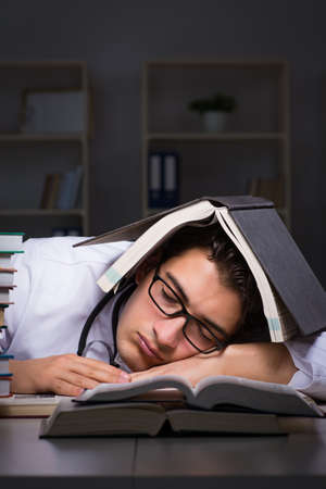 Medical student preparing for university exams at nightの写真素材