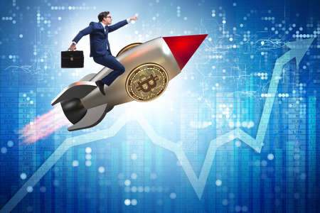 Businessman flying on rocket in bitcoin price rising conceptの写真素材