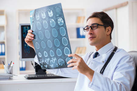 Doctor radiologist looking at x-ray imagesの写真素材