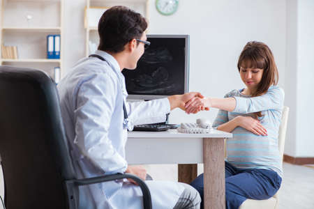 Pregnant woman visiting doctor for regular check-upの写真素材