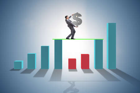 Young businessman in business concept with bar chartsの写真素材