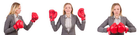Woman businesswoman with boxing gloves on whiteの写真素材