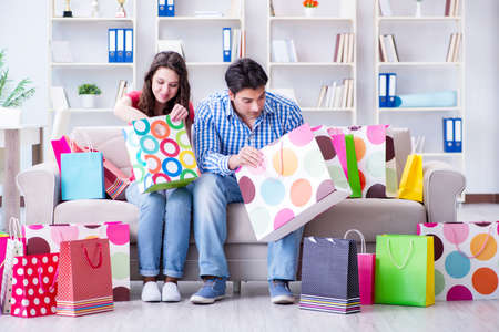 Young pair after shopping with many bagsの写真素材