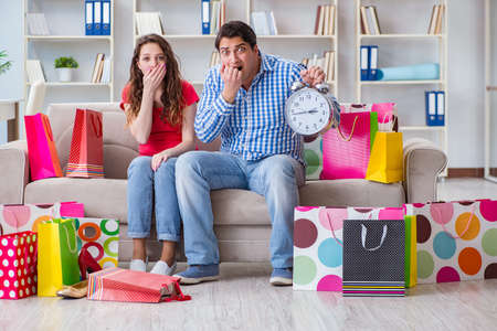 Young pair after shopping with many bagsの写真素材