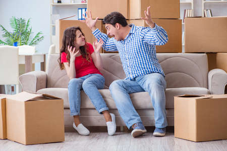 Young pair moving in to new house with boxesの写真素材
