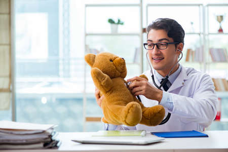 Pediatrician with toy sitting in the officeの写真素材