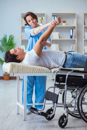 Patient undergoing rehabilitation recovery programme with doctorの写真素材