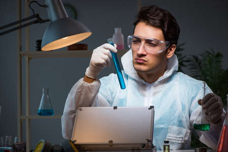 Forensic investigator working in lab looking for evidenceの写真素材