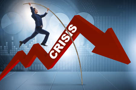 Businessman pole vaulting over crisis in business concept