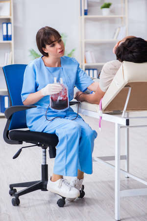 Patient getting blood transfusion in hospital clinicの写真素材
