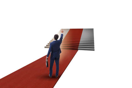 Young businessman climbing stairs and red carpet on white backgrの写真素材