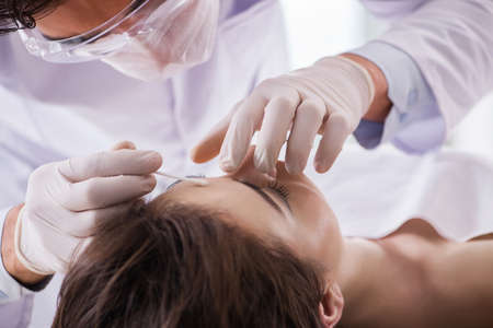 Police coroner examining dead body corpse in morgueの写真素材