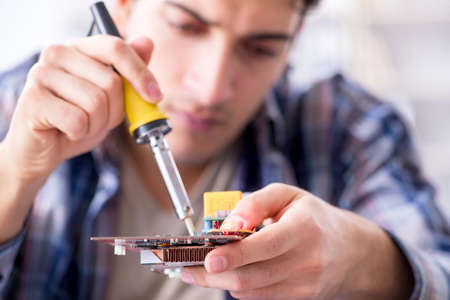 Professional repairman repairing computer in workshop
